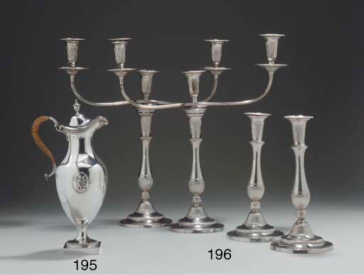A SET OF FOUR GEORGE III SILVER CANDLESTICKS WITH A PAIR OF THREE-LIGHT SHEFFIELD-PLATED BRANCHES*