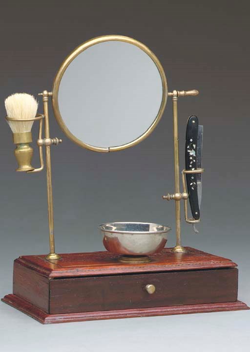 AN EDWARDIAN STAINED OAK AND BRASS SHAVING STAND WITH MIRROR,