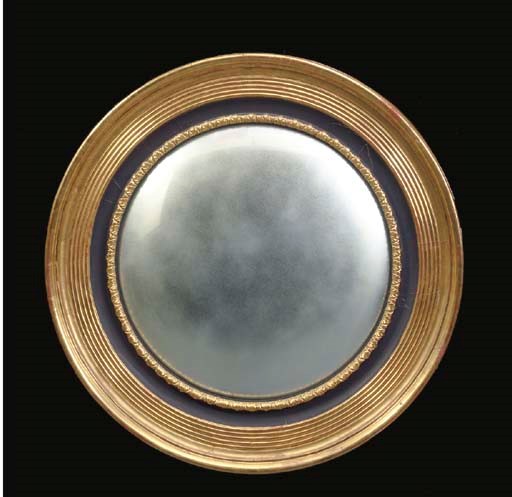 A REGENCY EBONIZED AND GILTWOOD CONVEX WALL MIRROR,