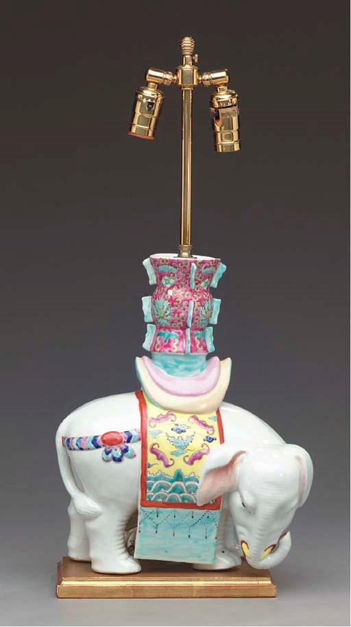 A PAIR OF CHINESE POLYCHROME-DECORATED PORCELAIN FIGURES OF ELEPHANTS MOUNTED AS LAMPS,