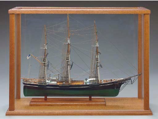 A CARVED POLYCHROME DECORATED WOOD MODEL OF A SAILING VESSEL IN A RECTANGULAR DUST CASE,