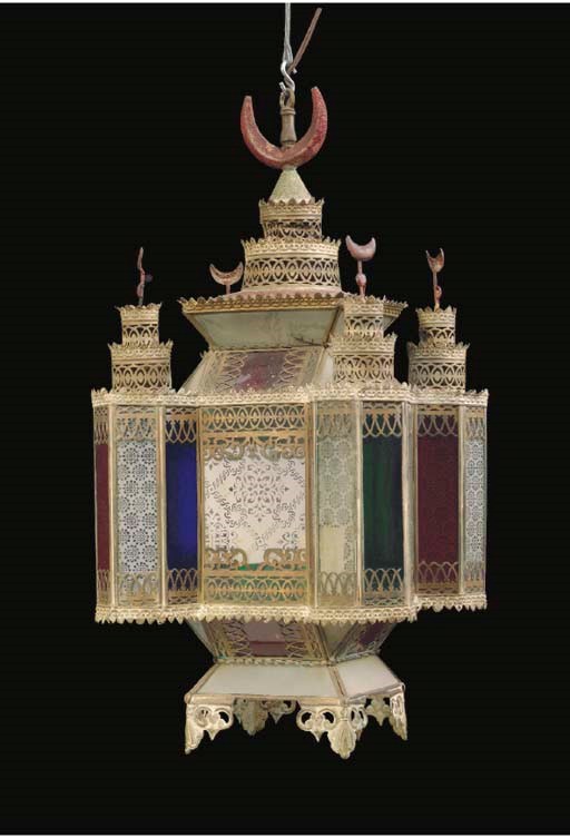A MOROCCAN METAL AND COLORED GLASS LANTERN,