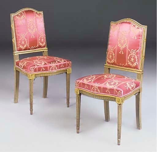 A pair of painted and parcel gilt side chairs
