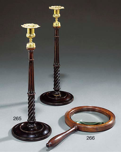 A PAIR OF MAHOGANY AND BRASS CANDLESTICKS