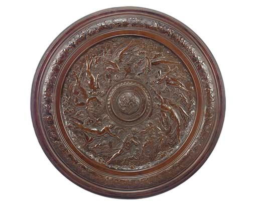 A BRONZE PATINATED METAL ROUNDEL