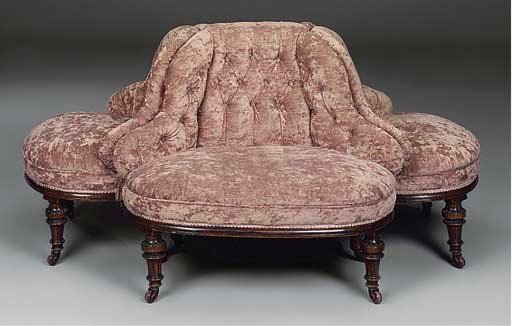 A VICTORIAN UPHOLSTERED AND WALNUT CONVERSATION SEAT