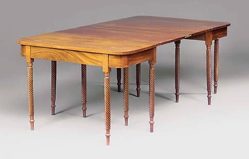 A MAHOGANY EXTENDING DINING TABLE