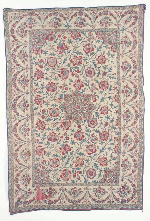 A chintz coverlet, the cotton ground block-printed and painted with a field of red and indigo exotic blooms and meandering leafy stems surrounding a central medallion, the borders with ribbon-tied bouquets and floral swags--51 x 34in. (130 x 86cm.), Indian, early 19th century, some tears