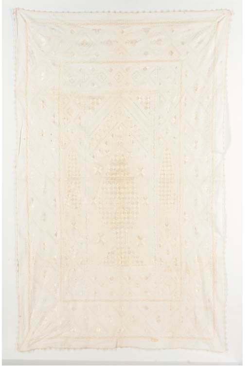 An embroidered whitework prayer-hanging, worked in ivory floss silks with a cypress tree beneath a mehrab, with drawn and pulled threadwork patterning--58 x 36½in. (147 x 93cm.), possibly Syrian, late 19th century
