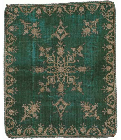 An embroidered bolster cover of emerald green silk velvet, worked in couched coiled metal thread and tinsel with butterflies and flowering vines--44 x 22in. (112 x 56cm.); and a square cushion cover of turquoise velvet similarly worked with flowers and scrolling leaves, backed with bright pink silk velvet--26 x 22in. (66 x 56cm.), Persian, 19th century