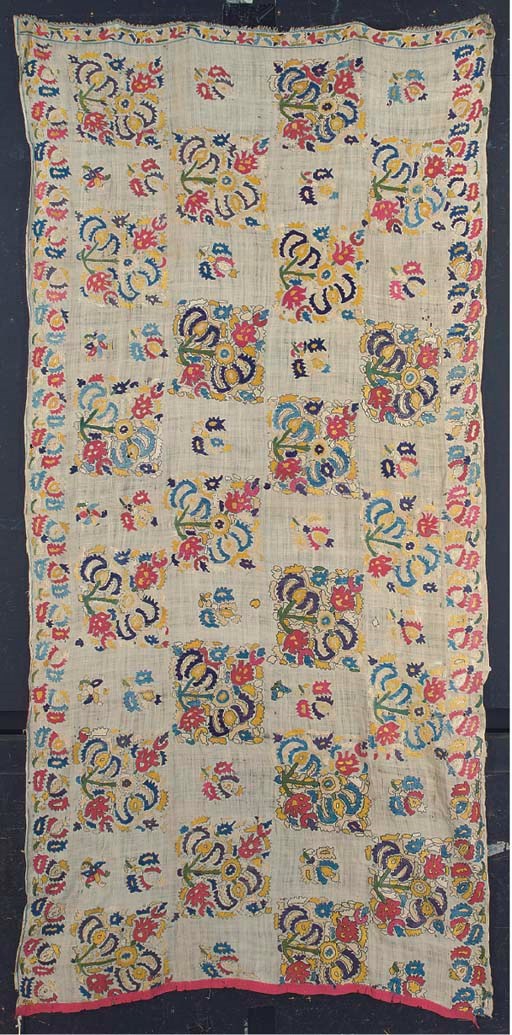 An embroidered mattress cover, the fine linen ground embroidered in polychrome floss silks with square stylised floral bouquets interspersed with smaller sprigs repeated on the border--35 x 75in. (89 x 190cm.), Tetouan, Morocco, 18th century, one lateral border missing, some repairs