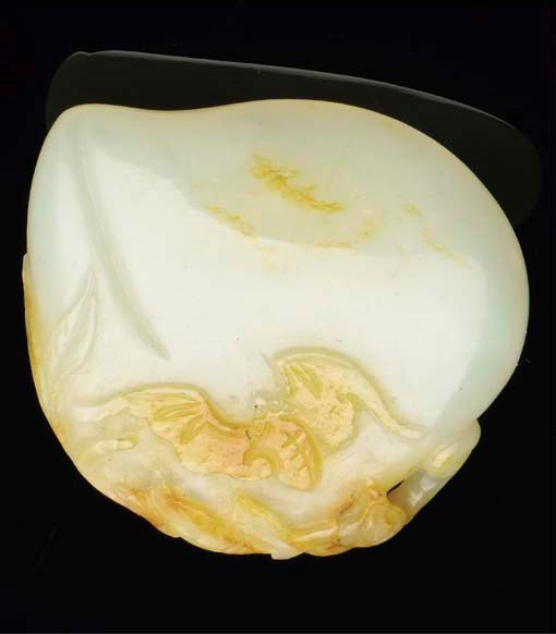A Chinese white and russet jade peach group, 19th/20th century