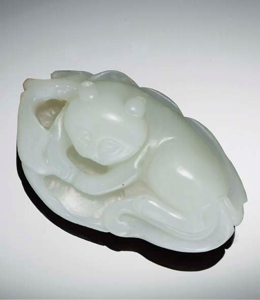 A Chinese pale celadon jade carving of a recumbent cat, 19th century