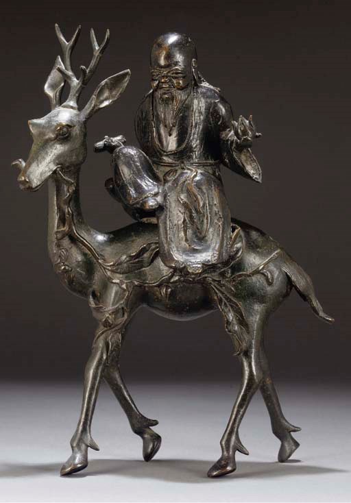 A Chinese bronze model of Shoulao seated on a deer, 16th/17th Dynasty