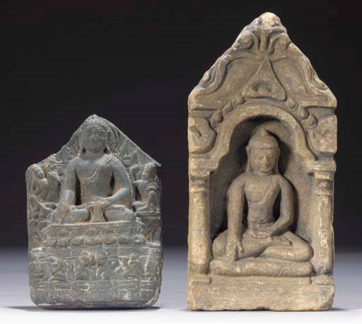 A grey stone fragmentary carving of Buddha.