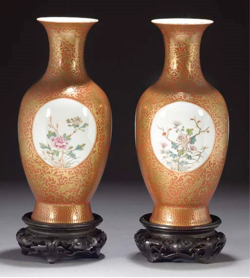 A pair of Chinese coral ground famille rose baluster vases, Guangxu marks and of the period