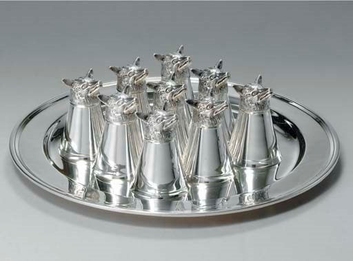 A SET OF NINE SILVER STIRRUP CUPS AND TRAY