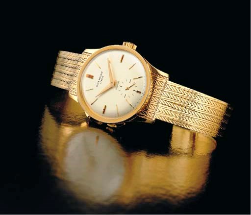 PATEK PHILIPPE. A FINE AND RARE 18K GOLD TWO TIME ZONE WRISTWATCH WITH JUMPING HOURS