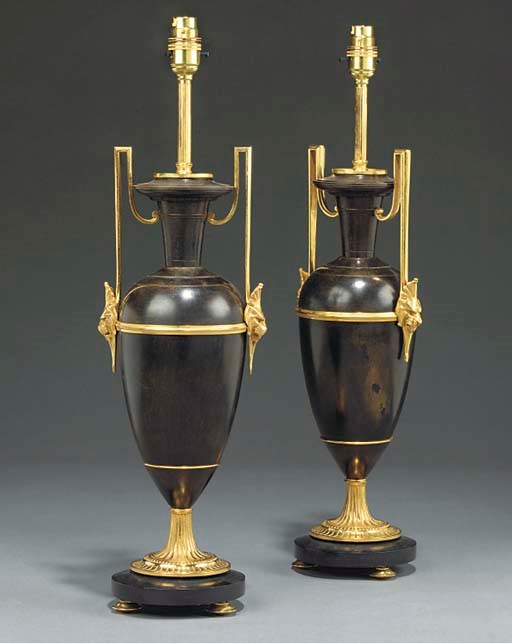A pair of French bronze patinated and gilt metal table lamps