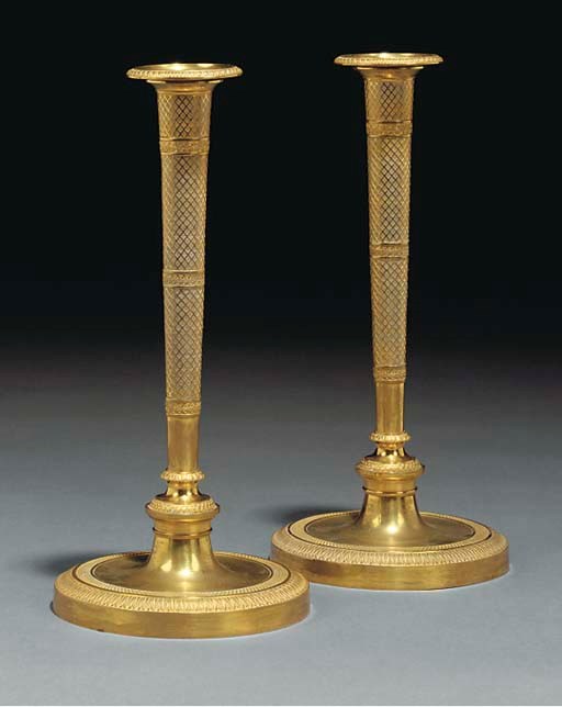 A pair of Empire ormolu candlesticks