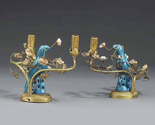 A pair of gilt metal and porcelain twin light table lamps