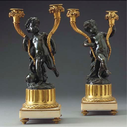 A pair of Napoleon III gilt and patinated bronze twin light candelabra