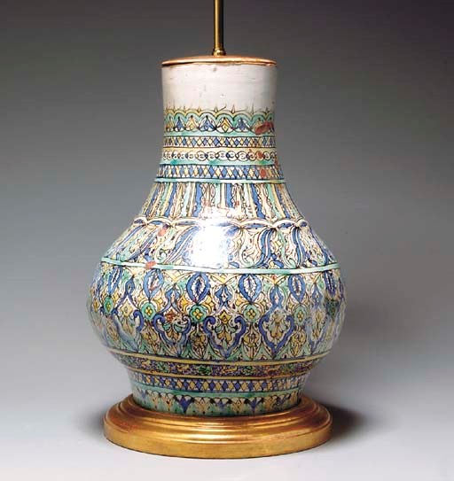 AN EARTHENWARE VASE MOUNTED AS A LAMP,