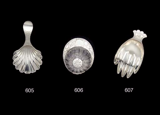 A GEORGE III SILVER HAND CADDY SPOON