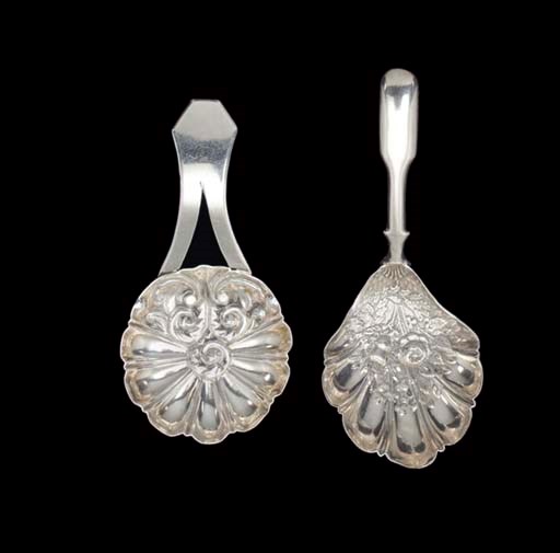 A GEORGE III SILVER CADDY SPOON AND A GEORGE IV EXAMPLE