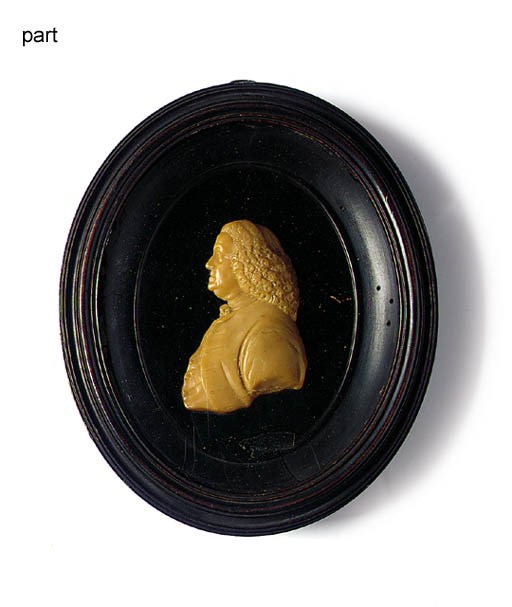 A DARK CREAM WAX PORTRAIT RELIEF OF BENJAMIN FRANKLIN