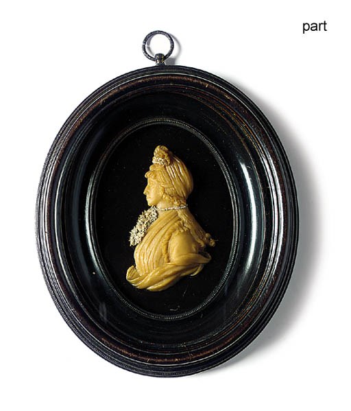 A DARK CREAM WAX PORTRAIT RELIEF OF A LADY