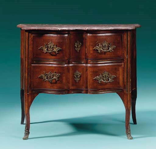 AN EARLY LOUIS XV ORMOLU-MOUNTED AND BRASS-INLAID KINGWOOD COMMODE