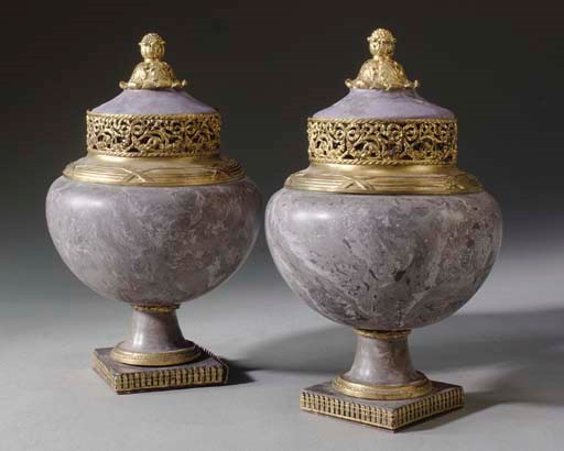 A PAIR OF GILT-METAL AND COMPOSITION URNS