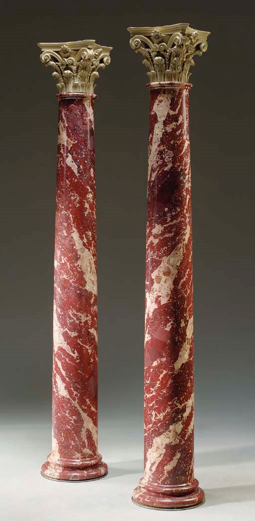 A PAIR OF MOTTLED RED SCAGLIOLA AND COMPOSITION COLUMNS