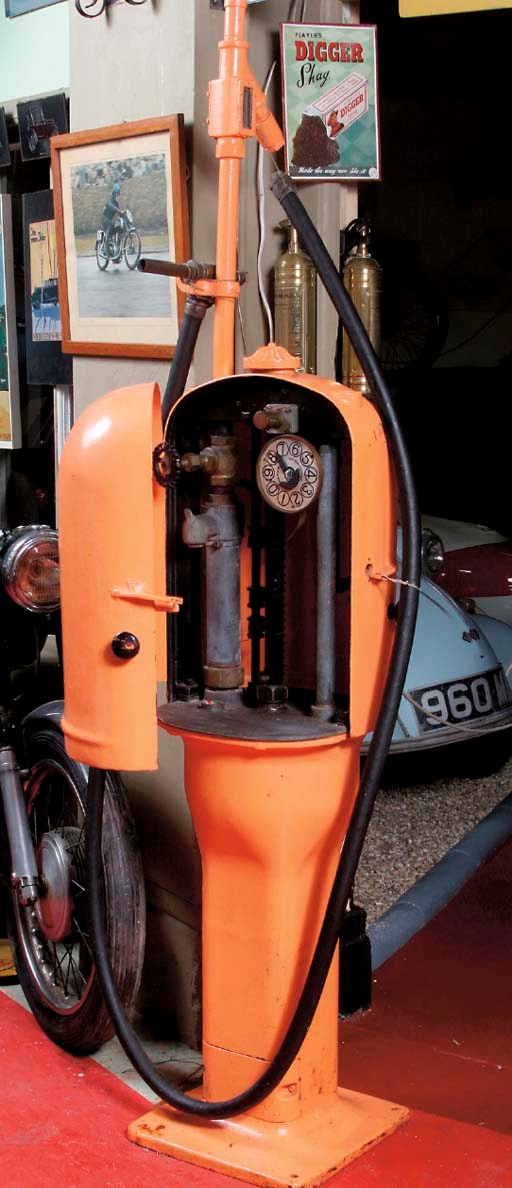 Gilbert & Barker - An early pre-war hand-cranked petrol-pump; pot-bellied pattern with cast iron base and frame; painted in orange livery; complete with hose and nozzle; c.1920s.