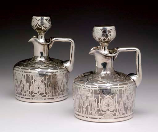 A PAIR OF AMERICAN SILVER OVERLAY GLASS DECANTERS AND STOPPERS,