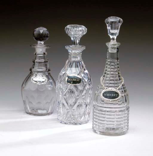 A GROUP OF EIGHT VARIOUS ENGLISH AND IRISH CUT-GLASS DECANTERS AND STOPPERS,