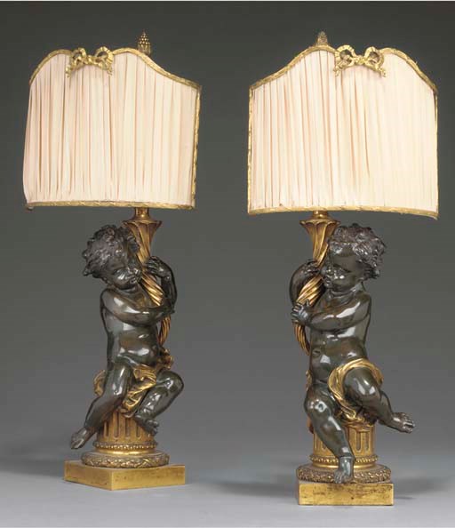 A pair of French gilt and bronze figural table lamps