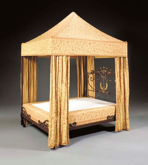 A FRENCH PARCEL-GILT AND RED-PAINTED CAST-IRON BED