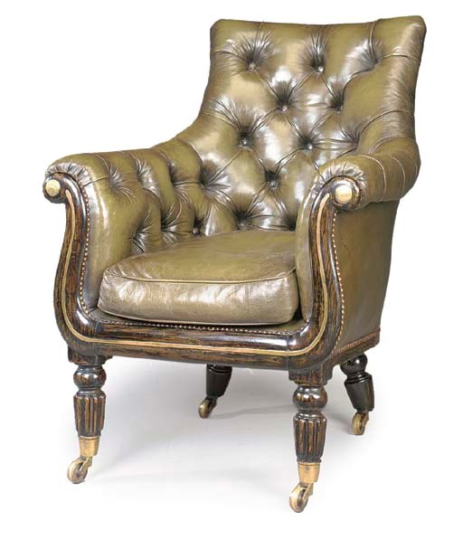 A GEORGE IV BRASS-MOUNTED EBONISED LIBRARY ARMCHAIR