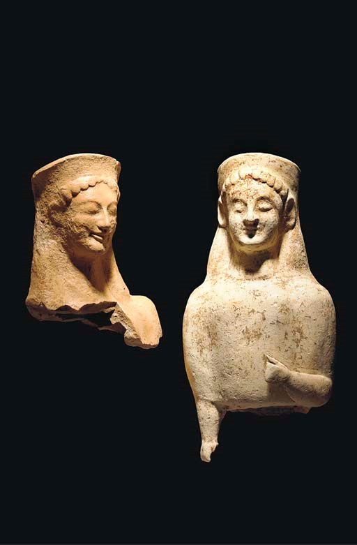 AN EAST GREEK TERRACOTTA FEMALE VOTIVE FIGURE