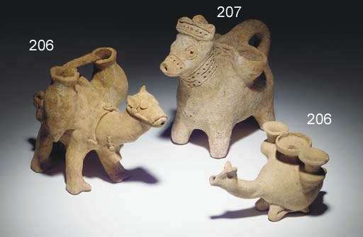 A NEAR EASTERN TERRACOTTA VESSEL IN THE FORM OF A LADEN DONKEY