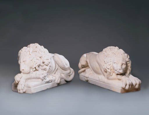 A PAIR OF ITALIAN MARBLE STATUES OF RECUMBENT LIONS