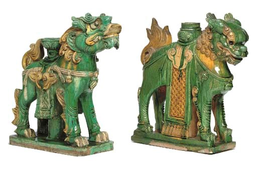 TWO CHINESE GREEN AND OCHRE-GLAZED TILEMAKER'S FIGURES OF BUDDHIST LIONS