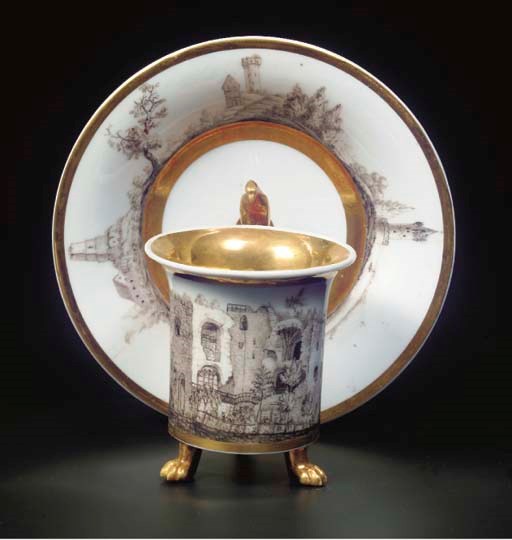 A Paris porcelain gilt tripod cabinet cup and saucer