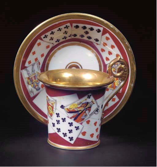A Paris porcelain gilt trompe l'oeil 'jeu de cartes' cabinet cup and saucer