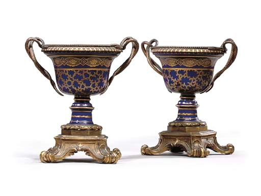 A PAIR OF RESTAURATION GILT-METAL-MOUNTED FRENCH PORCELAIN TWO-HANDLED URNS