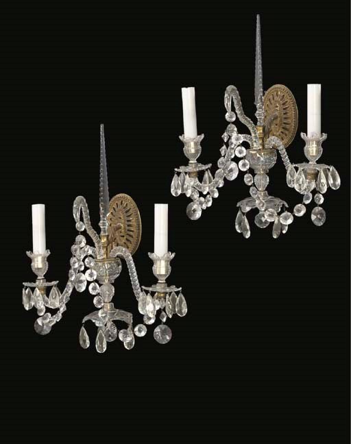 A SET OF TWELVE CUT-GLASS TWO-LIGHT WALL LIGHTS