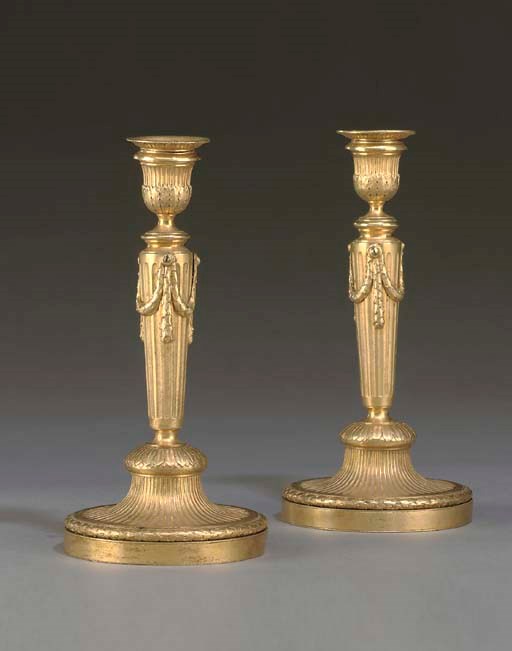 A PAIR OF GEORGE III ORMOLU CANDLESTICKS
