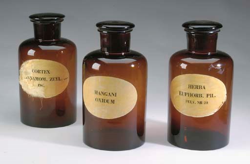 A SET OF THREE AMBER GLASS MEDICINE JARS WITH COVERS